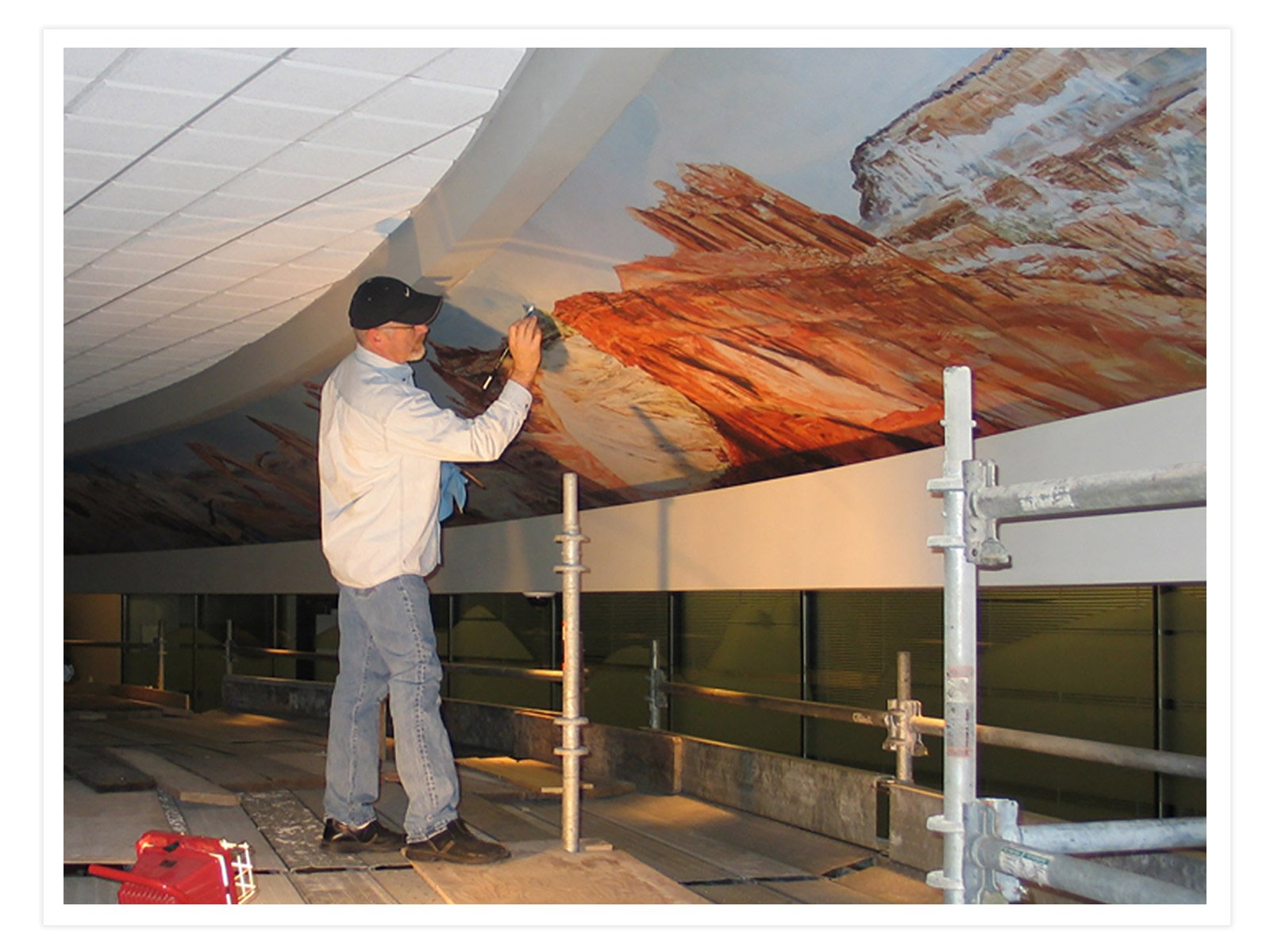 Whitney Jones touching up his mural of Utah 