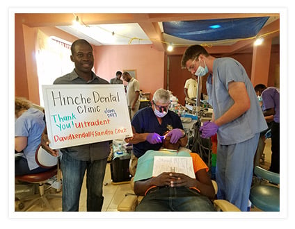 Dr. Tim Brown works on a patient at his Haiti clinic using an Ultradent VALO curing light